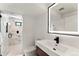 Stylish bathroom featuring a glass-enclosed shower, a modern vanity, and a lighted mirror at 220 Glencoe St, Denver, CO 80220