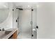 Modern bathroom with a glass shower, stone countertop and black fixtures at 220 Glencoe St, Denver, CO 80220