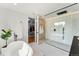 Bright bathroom with a freestanding tub, a modern shower, and an open doorway to the walk-in closet at 220 Glencoe St, Denver, CO 80220