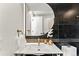 Contemporary bathroom showcasing modern fixtures, unique mirror, and stylish decor at 220 Glencoe St, Denver, CO 80220
