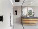 Beautiful bathroom featuring a double vanity, large mirrors, and a luxurious walk-in shower at 220 Glencoe St, Denver, CO 80220