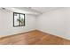 Bright bedroom with hardwood floors and a modern window overlooking the exterior at 220 Glencoe St, Denver, CO 80220