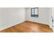 Sunny bedroom featuring hardwood floors, white walls, and a window for natural light at 220 Glencoe St, Denver, CO 80220