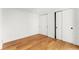 Neutral bedroom with sliding closet doors and light-colored, hardwood floors at 220 Glencoe St, Denver, CO 80220
