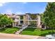 Stunning modern home featuring a manicured lawn and eye-catching architectural design at 220 Glencoe St, Denver, CO 80220