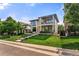 Stunning two-story home with modern design, stone accents, a well-manicured lawn, and a balcony at 220 Glencoe St, Denver, CO 80220