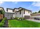A modern home featuring a well-manicured lawn, a pergola, and an attached garage at 220 Glencoe St, Denver, CO 80220