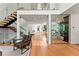 Open concept living area with fireplace, modern staircase, and custom wine storage at 220 Glencoe St, Denver, CO 80220