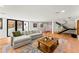Inviting living room features hardwood floors, large sectional, and modern staircase at 220 Glencoe St, Denver, CO 80220