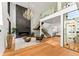 Bright living room with tall ceilings, modern fireplace, and elegant chandelier at 220 Glencoe St, Denver, CO 80220