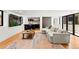Open-concept living room offers modern bar, hardwood floors and comfortable sectional at 220 Glencoe St, Denver, CO 80220