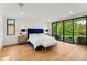 Spacious main bedroom with a large bed, access to a private balcony, and beautiful views at 220 Glencoe St, Denver, CO 80220