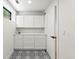 Clean mud room with patterned tile floor, a window, and white shaker-style cabinets at 220 Glencoe St, Denver, CO 80220