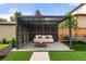Stylish backyard featuring a modern pergola with comfortable seating and a well-manicured lawn at 220 Glencoe St, Denver, CO 80220