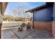 Cozy backyard patio with a fire pit, seating area, and string lights, perfect for relaxing outdoors at 2412 Windmill Dr, Longmont, CO 80504