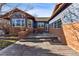 Spacious backyard patio with comfortable seating, stone pavers, and attractive brick details for outdoor living at 2412 Windmill Dr, Longmont, CO 80504