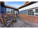 Backyard with brick accents, charming patio area, fire pit, and comfortable seating for outdoor enjoyment at 2412 Windmill Dr, Longmont, CO 80504