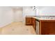 Basement bar area featuring a beverage refrigerator, cabinetry, and tile backsplash at 2412 Windmill Dr, Longmont, CO 80504