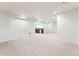 Expansive basement area showing carpet and white walls, offering versatile potential for customization at 2412 Windmill Dr, Longmont, CO 80504