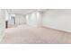 Spacious basement area with carpet and white walls, offering versatile space for recreation or storage at 2412 Windmill Dr, Longmont, CO 80504