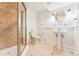 This renovated bathroom boasts a tiled shower, classic sink, and white wainscotting at 2412 Windmill Dr, Longmont, CO 80504