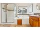 Bathroom featuring a tub, separate shower, and a window view of the outside at 2412 Windmill Dr, Longmont, CO 80504