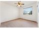 Bedroom with a ceiling fan, window with outside view, and neutral carpeting at 2412 Windmill Dr, Longmont, CO 80504