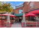 Inviting brewery and restaurant featuring an outdoor patio with red umbrellas and warm lighting at 2412 Windmill Dr, Longmont, CO 80504