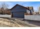 Exterior of the home, featuring a two-car garage and well-maintained landscaping at 2412 Windmill Dr, Longmont, CO 80504