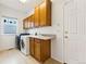 Laundry room with washer, dryer, upper cabinets and sink at 2412 Windmill Dr, Longmont, CO 80504