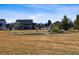 Community playground featuring swings and a colorful play structure, ideal for families at 2412 Windmill Dr, Longmont, CO 80504