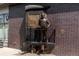 Bronze statue of a figure standing on a train platform against a brick wall background at 2412 Windmill Dr, Longmont, CO 80504