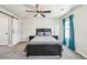 Inviting bedroom with a comfortable bed, side tables, and a window with blue curtains, creating a serene space at 1492 Red Cliff Way, Castle Rock, CO 80109