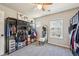 Bright bedroom features gray carpet, natural light and open closet system at 1492 Red Cliff Way, Castle Rock, CO 80109