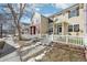 Front exterior view of a charming townhome with a white picket fence at 1492 Red Cliff Way, Castle Rock, CO 80109