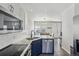 Stylish kitchen with stainless steel appliances, granite countertops, and subway tile backsplash, open to dining area at 1492 Red Cliff Way, Castle Rock, CO 80109