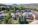 Sweeping aerial view of a neighborhood with a large home featuring a deck, bay window, and solar panels at 58 Rogers Ct, Golden, CO 80401