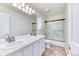Bathroom has a double sink vanity, white cabinets, and enclosed shower at 58 Rogers Ct, Golden, CO 80401