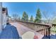 Expansive wooden deck with scenic views of the surrounding landscape and mature trees at 58 Rogers Ct, Golden, CO 80401