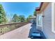 Large wooden deck perfect for entertaining, with a view of the treelined backyard at 58 Rogers Ct, Golden, CO 80401