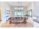 Bright dining room featuring a long wooden table, chandelier, and large windows for an inviting and open space at 58 Rogers Ct, Golden, CO 80401