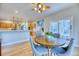 Cozy dining space with open access to the kitchen and outdoor views from the sliding glass door at 58 Rogers Ct, Golden, CO 80401