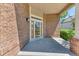 Inviting front porch with brick facade and wood-framed glass front door at 58 Rogers Ct, Golden, CO 80401