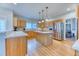 Modern kitchen featuring wood cabinets, marble countertops, stainless steel appliances and hardwood floors at 58 Rogers Ct, Golden, CO 80401