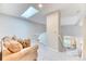 Light-filled landing area features carpet floors, a skylight and a comfortable sofa at 58 Rogers Ct, Golden, CO 80401