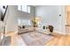 Bright living room featuring vaulted ceilings, large windows, and hardwood floors providing an open and inviting space at 58 Rogers Ct, Golden, CO 80401