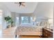 Spacious main bedroom with hardwood floors, a ceiling fan, large windows, and sliding doors leading to a balcony at 58 Rogers Ct, Golden, CO 80401