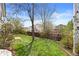 Large backyard with lush green lawn, mature trees, and privacy fence at 5133 S Liverpool Way, Centennial, CO 80015
