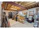 Unfinished basement with exposed beams, some drywall and carpet, and cluttered with storage boxes at 5133 S Liverpool Way, Centennial, CO 80015