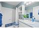 Bathroom featuring a shower and tub combination, blue accent paint, and a white sink and cabinet at 5133 S Liverpool Way, Centennial, CO 80015